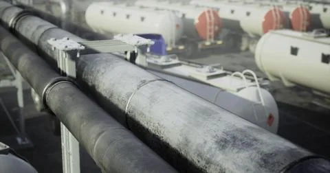 Industrial pipes and tanks at a processing facility under cloudy sky Stock Illustration