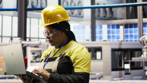 Industrial plant engineer using laptop to implement automated workflows Stock Footage 307360747
