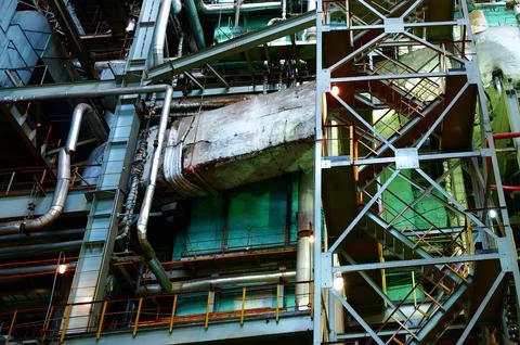 Industrial plant interior showcasing complex piping and structural elements in a Stock Photos