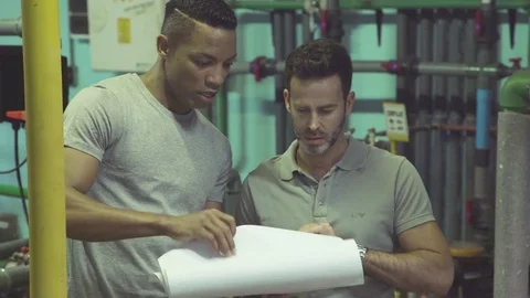 Industrial plant workers at work looking at blueprint Stock Footage 75168398