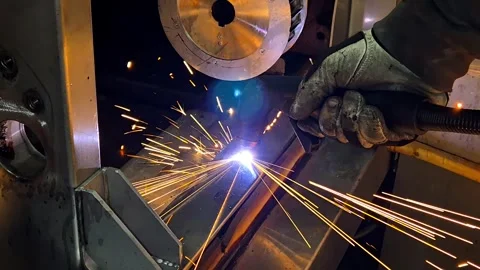 Industrial plasma cutting machine working on steel plate. Worker in safety glove Stock Footage 333531414