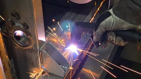 Industrial plasma cutting machine working on steel plate. Worker in safety glove Stock Footage 333531415