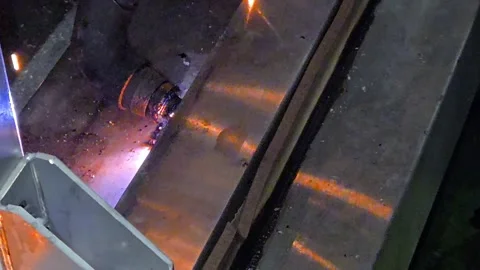 Industrial plasma cutting machine working on steel plate. Worker in safety glove Stock Footage 333531420