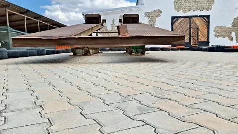 Industrial Platform Trailer Stands Across Paved Construction Yard Stock-Footage 335672123