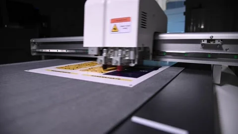 Industrial plotter cuts a template on a cardboard packaging for products. real 動画素材 165710788
