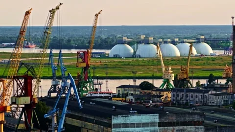 Industrial port cargo bulk material unloading cranes and Horton spheres LPG Stock Footage 315260381