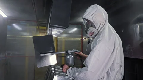 Industrial Powder Coating Process in Action, Worker in Full Gear Sprays Metal Stock Footage 312167511