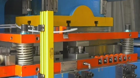 Industrial Power Press Machine Molding Heavy Metal Parts in a Busy Workshop Stock Footage 340486502