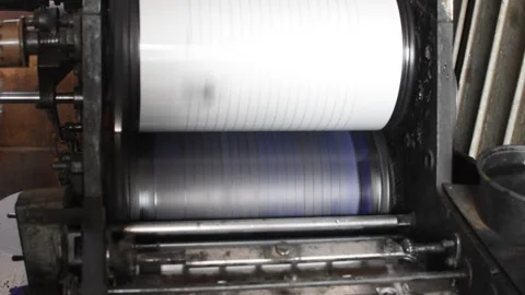 Industrial printing machine rollers in motion during paper processing. 動画素材 326933596