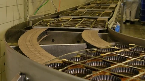 Industrial process of Empty pastry molds on a conveyor belt in a bakery factory Stock Footage 81711334