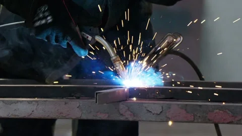 Industrial process. Metalwork assembly. Worker welding in protective helmet. Video stock 246189381