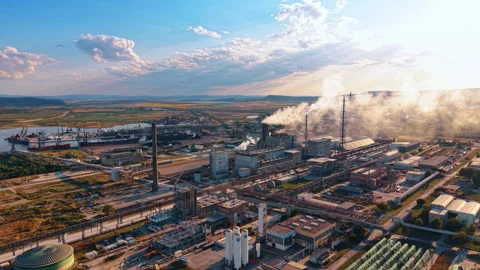 Industrial processing complex and cargo port emitting steam. Oblique drone view Stock Footage 339368286