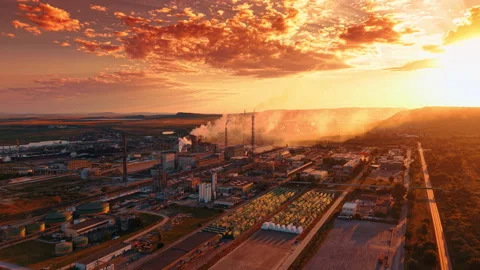 Industrial processing complex beside harbor at sunset. Wide aerial view of Stock Footage 339368524