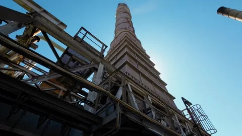 Industrial processing plant in backlight with massive chimneys Stock Footage 345659346