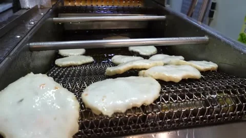 Industrial Production of Authentic Korean Fish Cakes (Eomuk) on Conveyor Belt Stock Footage 337374590