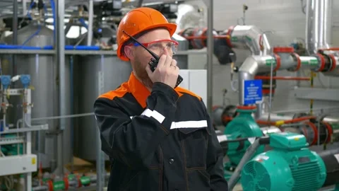 An industrial production operator stands in the workshop of a pumping station Stock Footage 170992071