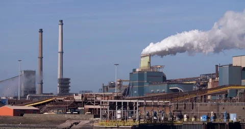 Factory Tata Steel with smoking chimneys on a sunny day, IJmuiden, The  Netherlands Stock Photo