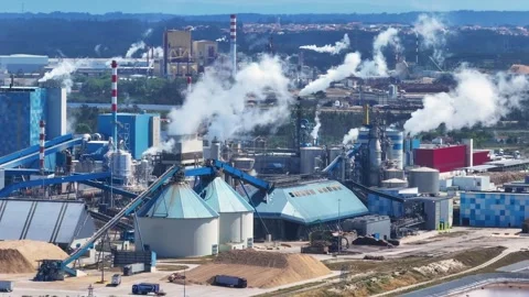 Industrial pulp and paper mill emitting steam and smoke Stock Footage 339674896