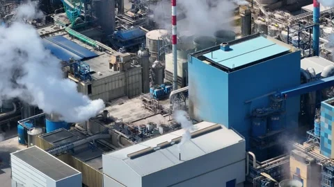 Industrial pulp and paper mill aerial view with smoke rising Stock Footage 340312443