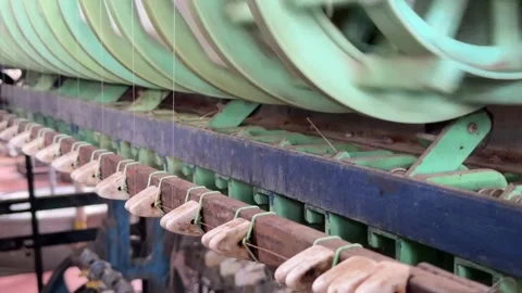 Industrial reels wind continuous silk filaments onto spools during cocoon 库存影片 329680374