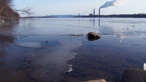 Industrial river pollution. view of factory pipes emitting smoke and steam .. Stock Footage 337859050