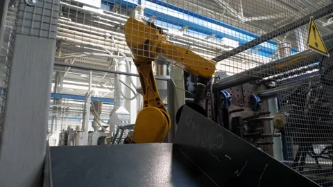 Industrial robot at work in the factory of plastic products. Stockbeeldmateriaal 140053766