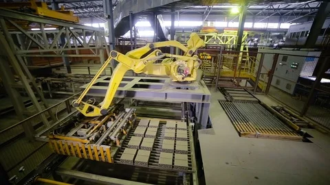 Industrial robotic arm manufacturing bricks. Timelapse Stock Footage