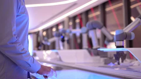 Industrial robotics engineer man using touch screen display, futuristic robot Stock Footage 170478723