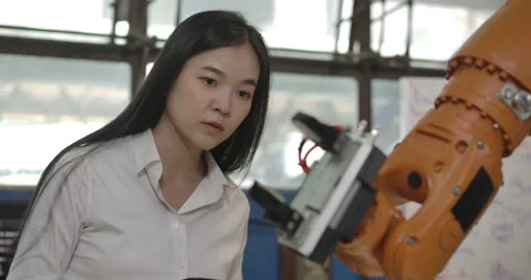 Industrial Robotics Engineer is Testing and Program Robot Arm. Stock Footage 153062644