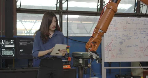 Industrial Robotics Engineer Uses Tablet to Program Robot Arm. Stock Footage 153062459