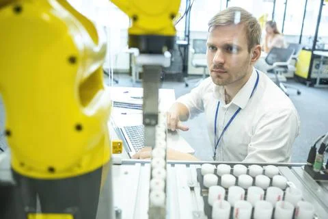 Industrial Robots Development An engineer developing the industrial robot.... Stock Photos