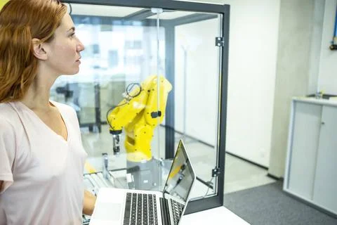 Industrial Robots Development An engineer developing the industrial robot.... Stockfoto's