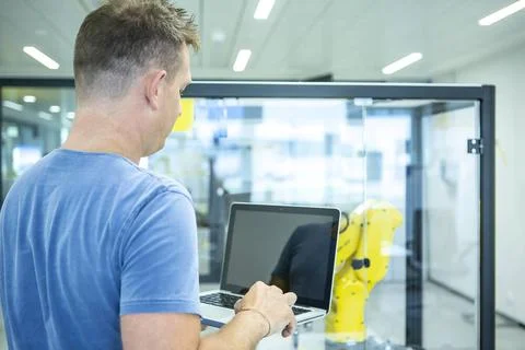 Industrial Robots Development An engineer developing the industrial robot.... Foto stock