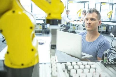Industrial Robots Development An engineer developing the industrial robot.... Foto stock