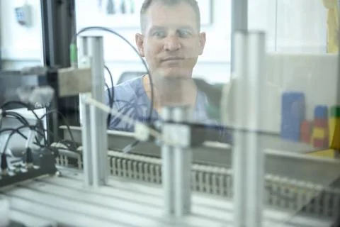 Industrial Robots Development An engineer developing the industrial robot.... Stock Photos