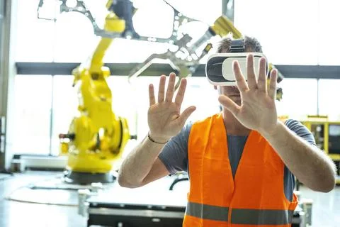 Industrial Robots Remote Control AR The engineer controls an industrial ro... Stockfoto's