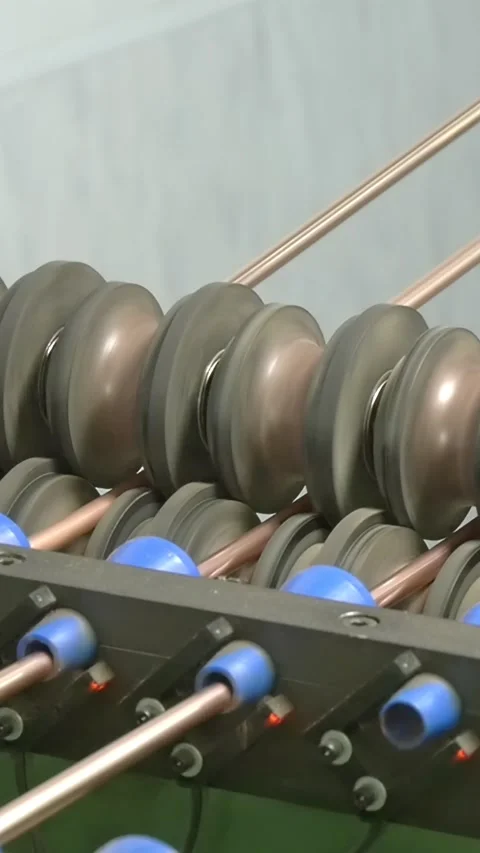 Industrial Rollers Guide Copper Tubes in a Dynamic Manufacturing Process Video stock 344607153