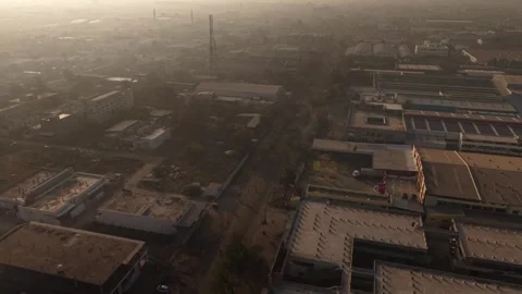 Industrial rooftops and vacant plots in a dense urban manufacturing zone during 動画素材 334503134