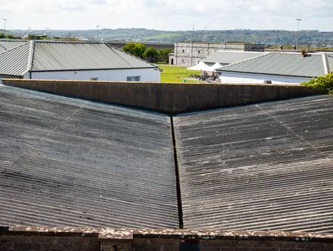 Industrial rooftops with distant landscape view Stock Photos