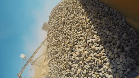 Industrial sand mining. Loader dumping gravels into a truck at sand Stock Footage 95782642