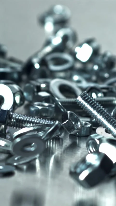 Industrial scene featuring mixed nuts bolts and reflective surfaces Filmed on a Stock Footage 335395684