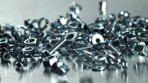 Industrial scene featuring mixed nuts bolts and reflective surfaces Filmed on a Stock Footage 335412452