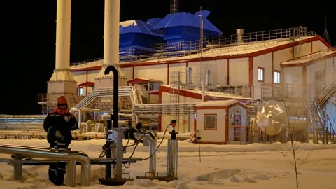 Industrial scene featuring worker in cold environment managing steam. Captures Stock Footage 282470360