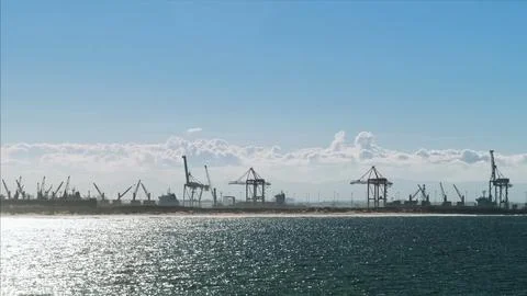 Industrial seaport or with cargo cranes and ships under a clear blue sky. Gentle Stock Photos
