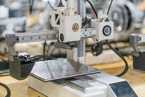 Industrial setting featuring a flexible robotic arm, positioned over a table  Stock Photos