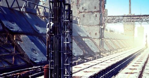 Industrial setting with machinery and structures under bright sunlight Stock Illustration