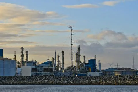 Industrial setting. Oil refinery, pipes with smoke. Stock Photos