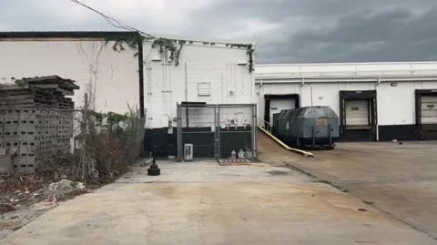 Industrial setting pan of loading dock area Stock Footage 239869941