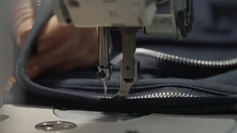 Industrial sewing machine attaching zipper to fabric Stock Footage 331982173
