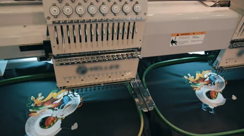 Industrial sewing machine embroiders on program the Chinese dragon  Stock Footage 68369064